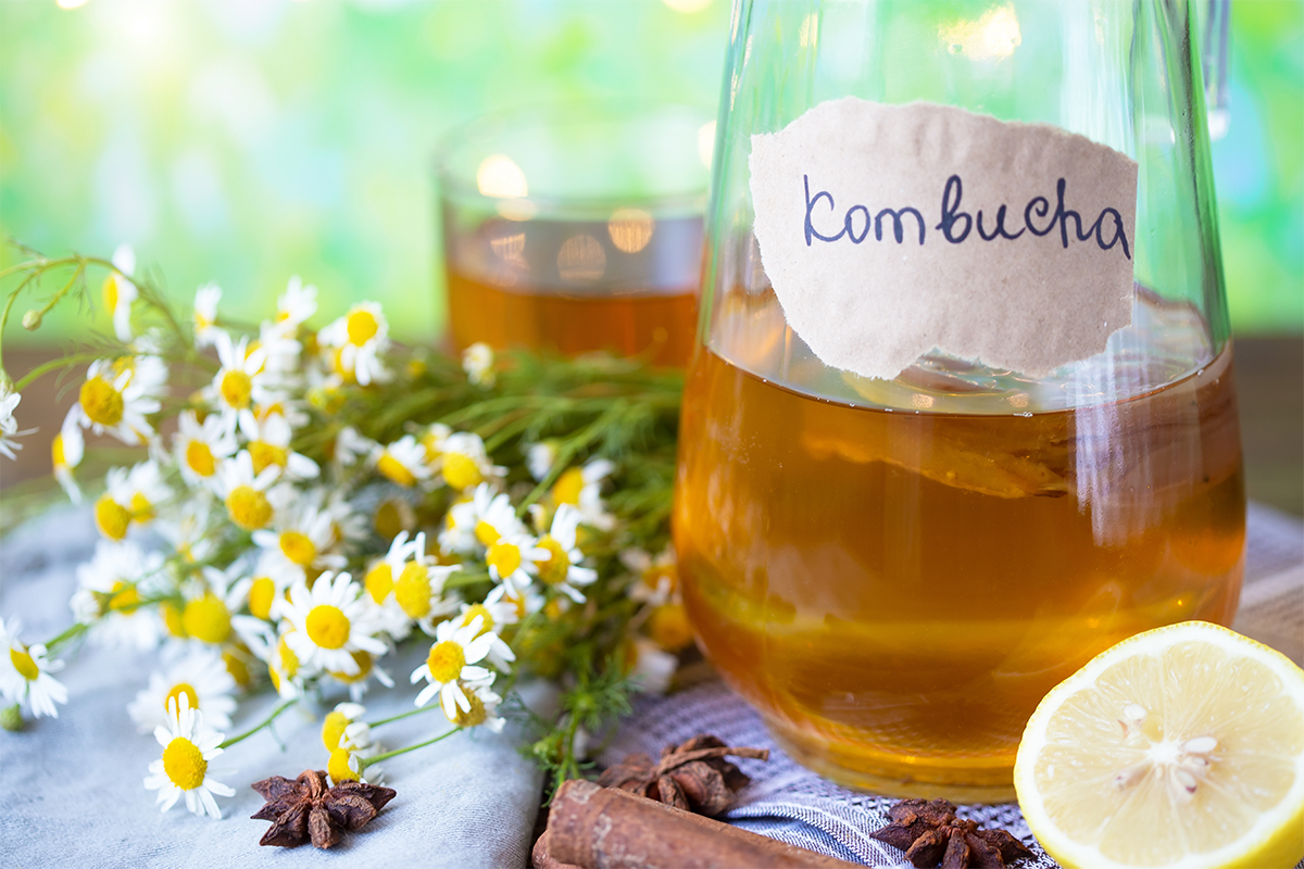 Kombucha (mit Tee selber gemacht) steht auf einem Gartentisch [Foto: AdobeStock_Natalya]