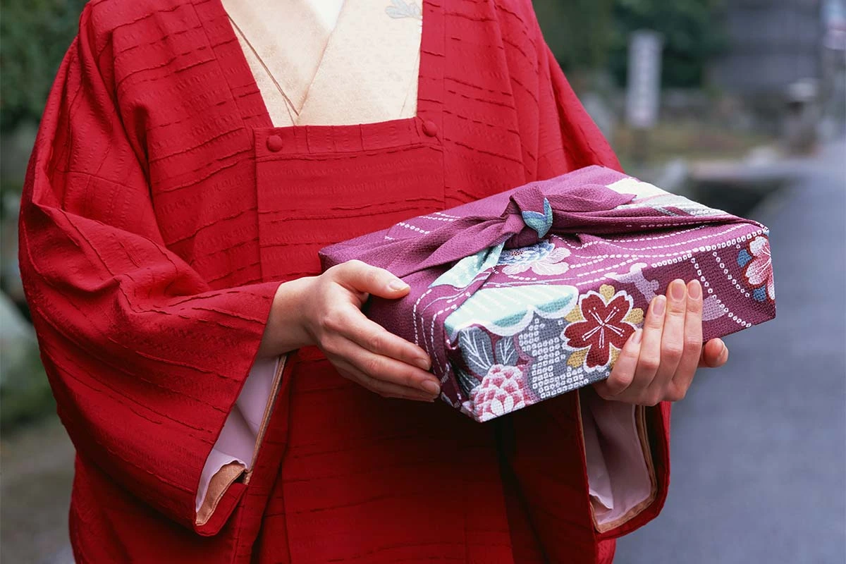 Japanerin traegt ein Furoshiki [Foto: AdobeStock_MH-STOCK]