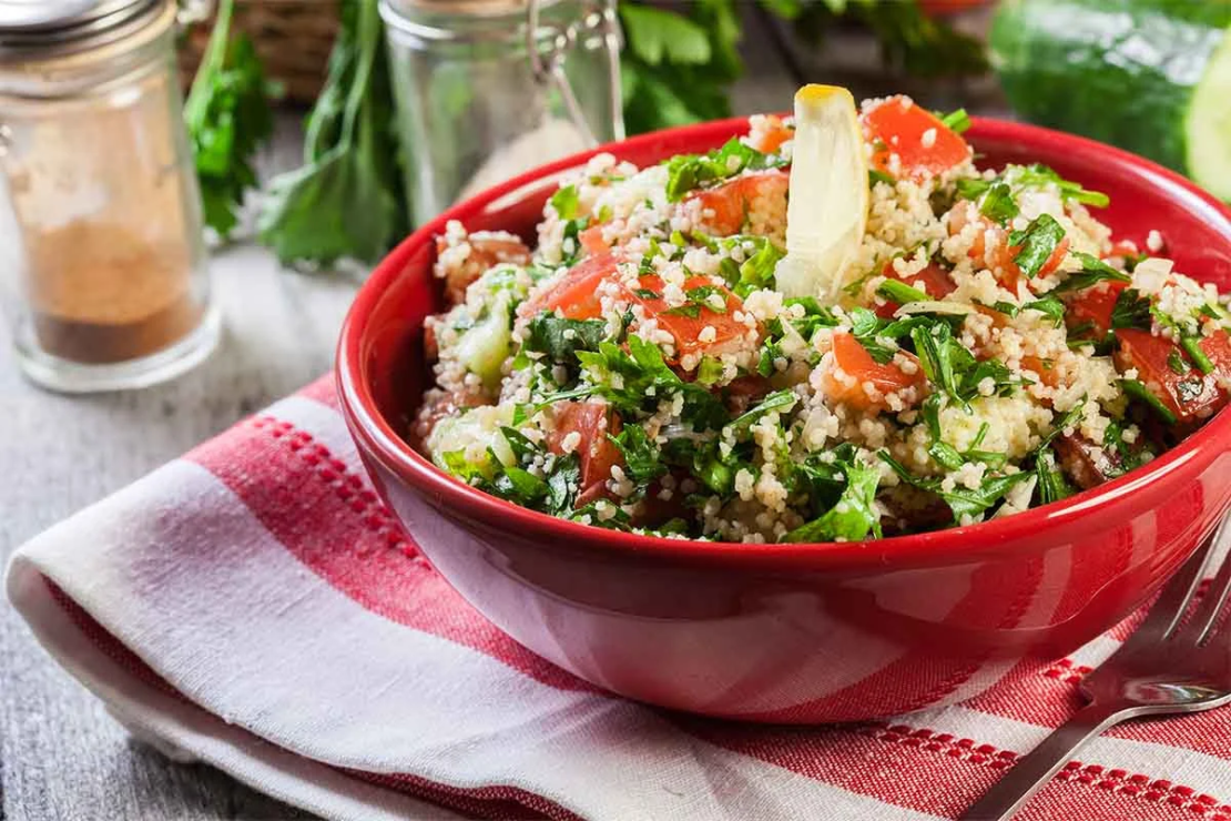 Couscous Sommersalat in einer Schale mit Petersilie [Foto: AdobeStock_Sławomir Fajer]